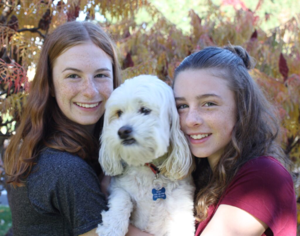 Two girls and their dog